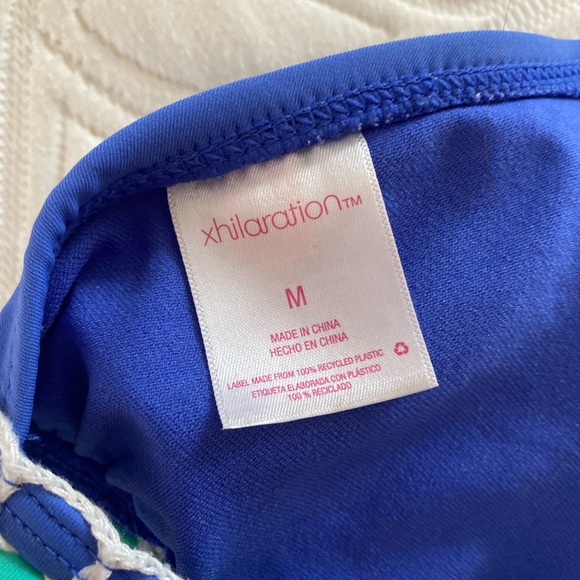 Blue bikini top with pink green and yellow detailing lacing. - Picture 3 of 3